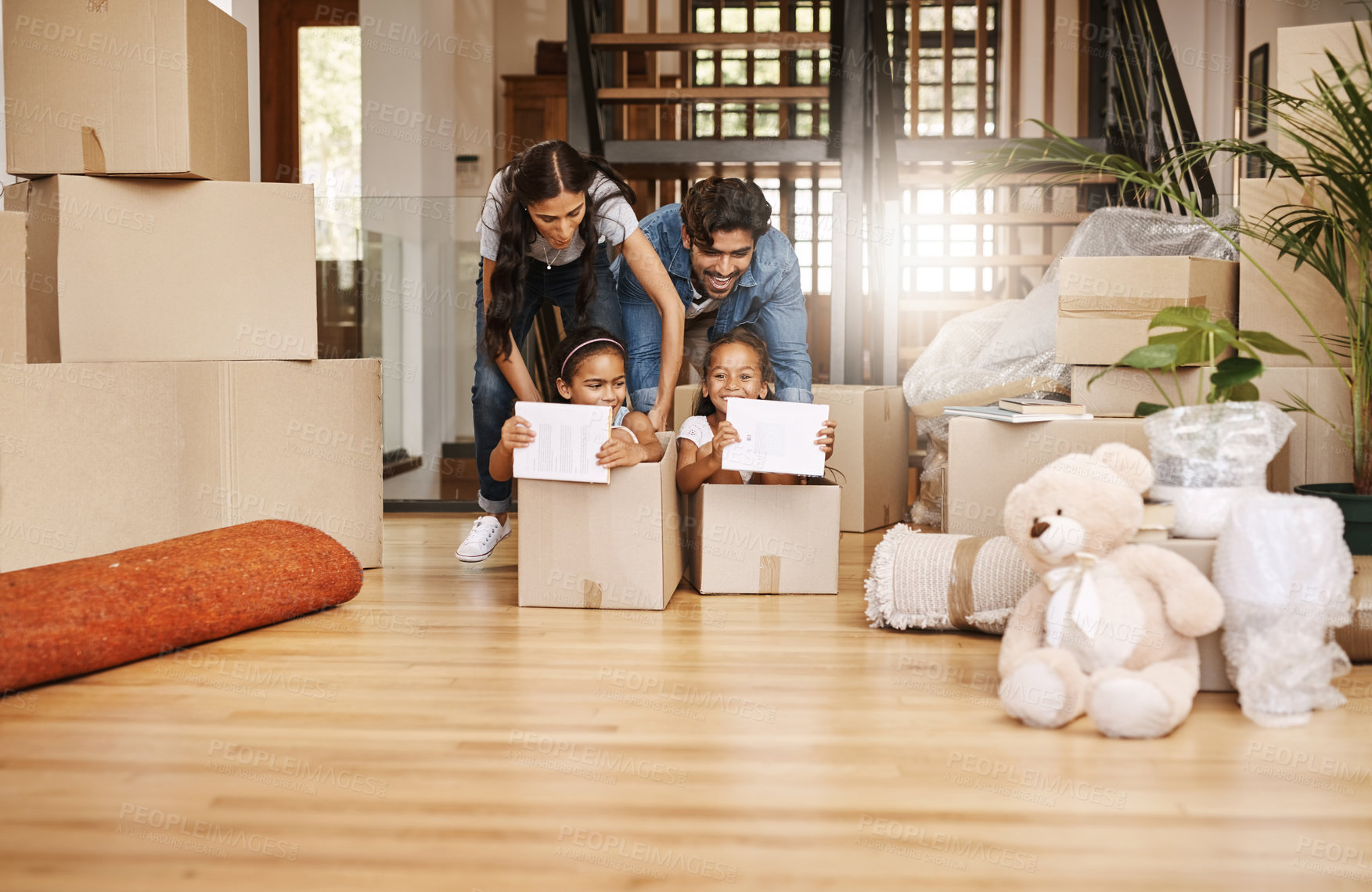 Buy stock photo Full length shot of an affectionate young family having fun on moving day