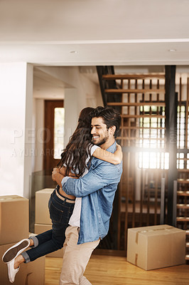Buy stock photo Cropped shot of an affectionate young couple embracing on moving day