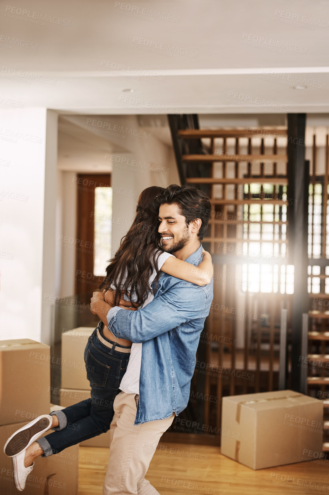 Buy stock photo Happy couple, hug and love with box for moving in new home, relocation or fresh start together. Young man, woman or lovers with affection for embrace, support or trust in apartment building or house