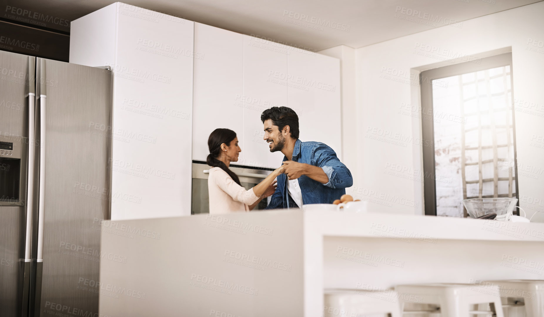 Buy stock photo Couple, home and happy in kitchen with dancing for fun, bonding and support as lovers. People, relationship and smile or laughing with music for care, trust and affection on break as soulmates