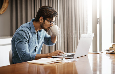 Buy stock photo Man, remote work and drinking coffee at laptop in home at table for planning, research and online network. Focused male freelancer drink cup of tea while working on computer, internet and website 