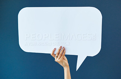 Buy stock photo Hand, speech bubble and woman in studio with banner, news or announcement on blue background. Mockup, poster and girl fingers with billboard for social media, advertising or opinion, vote or space