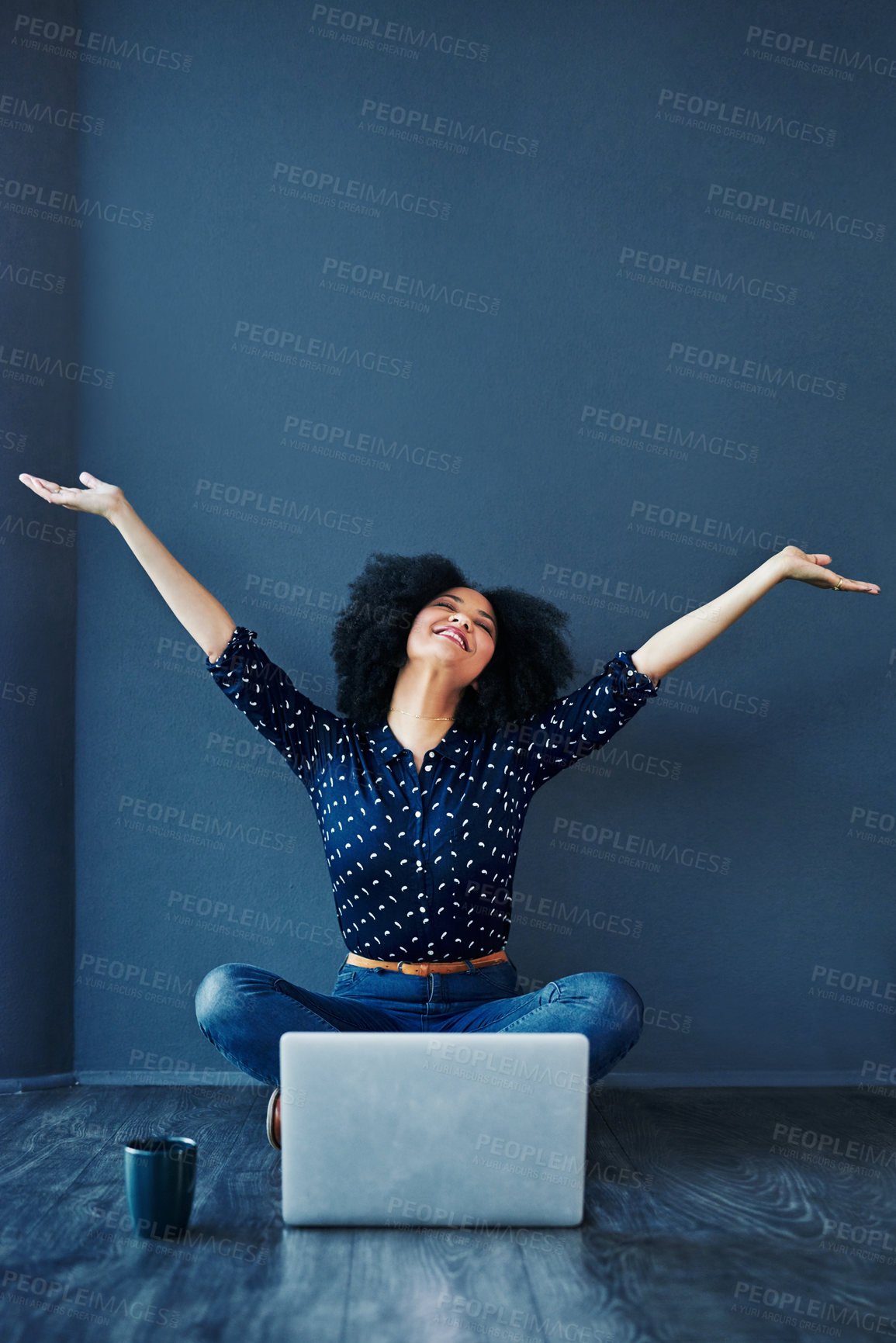 Buy stock photo Laptop, success and businesswoman in celebration on the floor by a blue wall with a mug. Happy, smile and excited professional female employee with an achievement or goals to celebrate with computer.