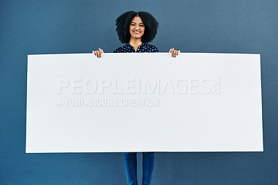 Buy stock photo Space, poster and portrait of happy woman in studio with banner for news, social media or advertising on blue background. Paper, billboard and female smile with mockup, sticker and branding promotion