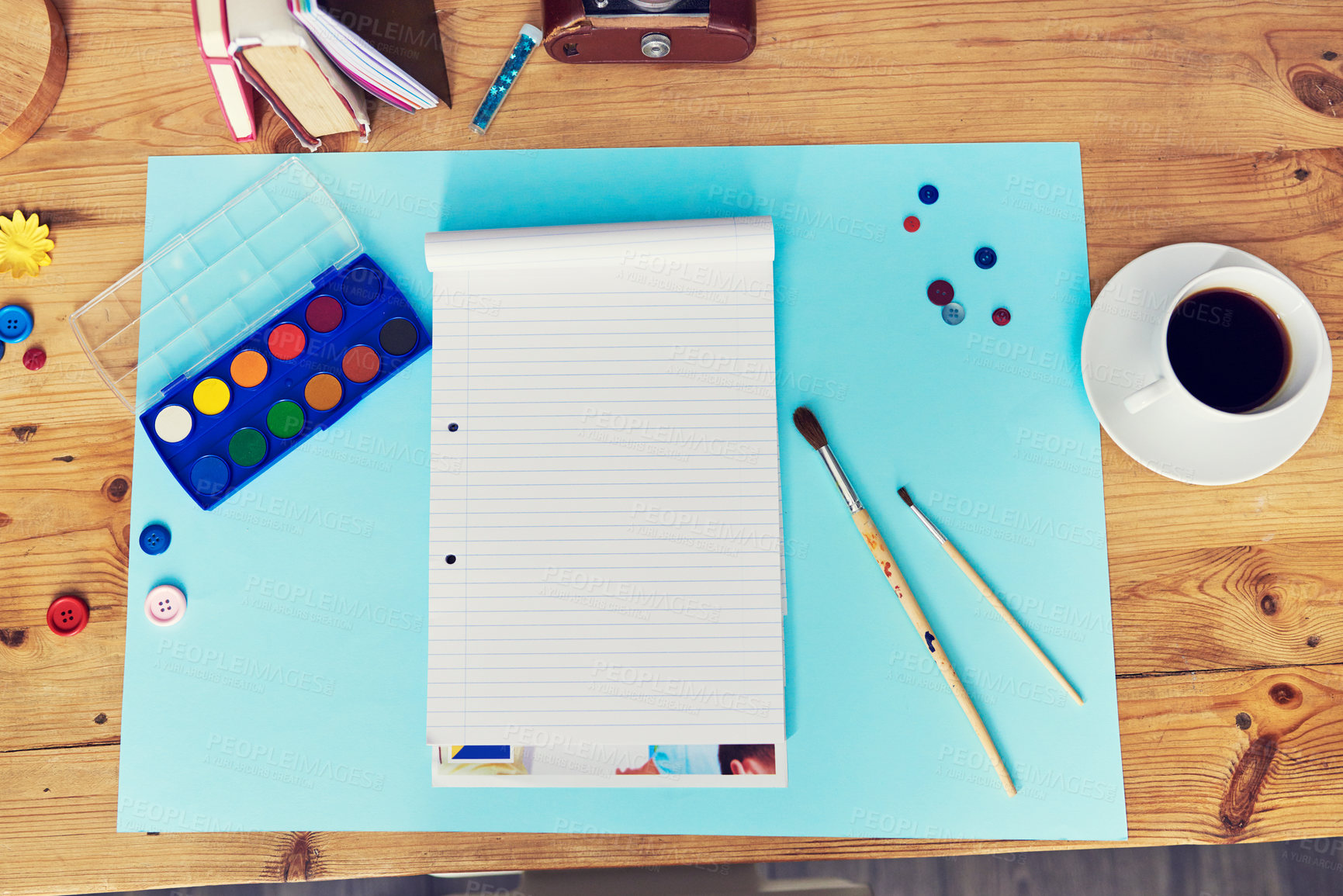 Buy stock photo Notebook, paint and above with creative workspace for art, design or colorful activity on desk. Top view of empty space with book, brushes and color palette for creativity on wooden table or mockup