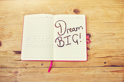 Buy stock photo High angle shot of a creative workstation with a notebook that has the words “dream big”written on it