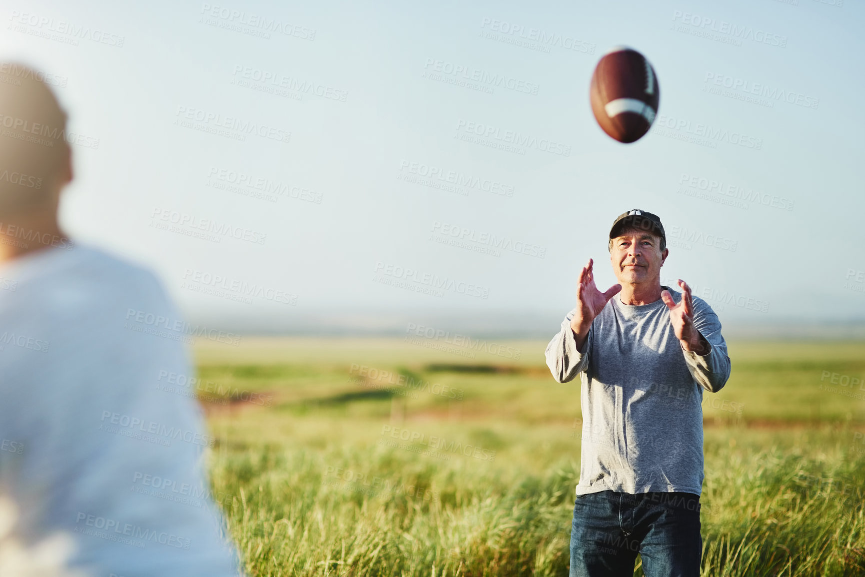 Buy stock photo Father, field and son with football, playing and training with fun, nature and cardio with love. Outdoor, family or single parent with boy, kid or childhood with sunshine, sports or active with hobby