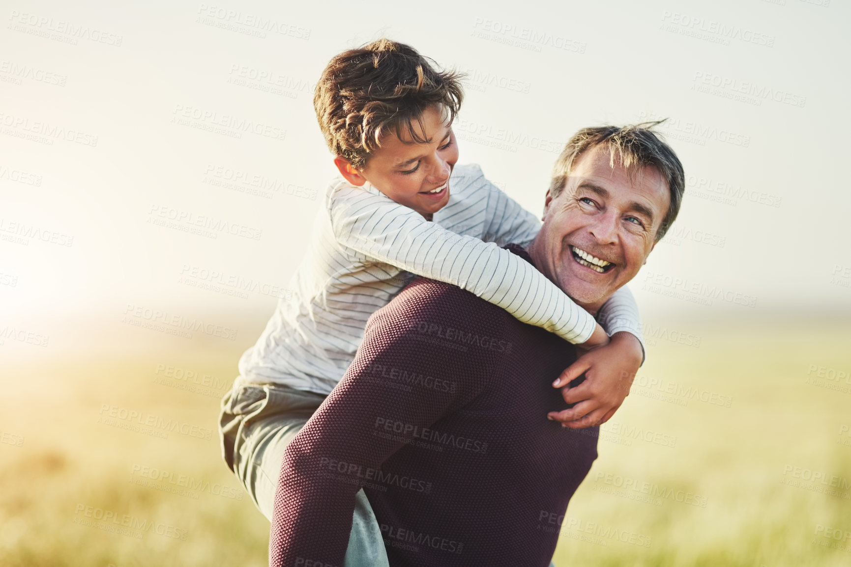 Buy stock photo Smile, father and piggyback of son in nature, kid and love of family in space, outdoor and carrying. Countryside, dad and visit to Texas with boy for fresh air, man and bonding with child in farm