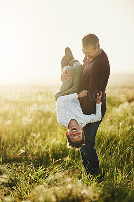 Buy stock photo Shot of a father and son having fun together outdoors