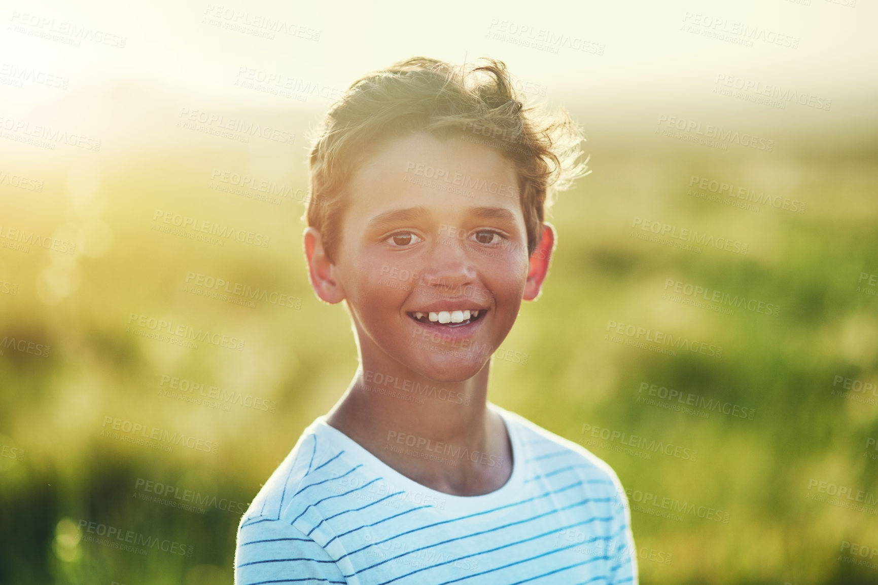 Buy stock photo Boy, portrait and happy in summer, field and outdoor for holiday, adventure and playful in countryside. Child, face and excited with smile at park, grass or farm in nature with sunshine in Argentina