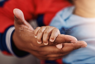 Buy stock photo Parent, baby and holding hands in home for support, care and bonding for child development or growth. People, newborn and closeup as family for love, trust and relax on maternity break for parenthood