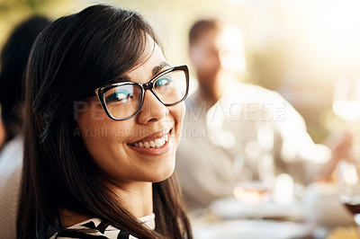 Buy stock photo Cropped portrait of an attractive young woman sitting around the Thanksgiving table with her family