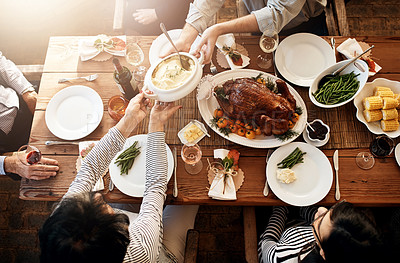 Buy stock photo Food, people and eating together at table for holiday celebration or dinner party. Above group of family or friends hands sharing healthy lunch with chicken or turkey, vegetables and wine drinks