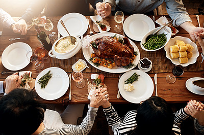 Buy stock photo Food, holding hands and people praying together at table to celebrate holiday, Christmas or thanksgiving. Above family or friends group prayer for gratitude, chicken or turkey for lunch or dinner