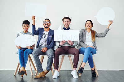 Buy stock photo Shot of a diverse group of creative employees holding up speech bubbles inside