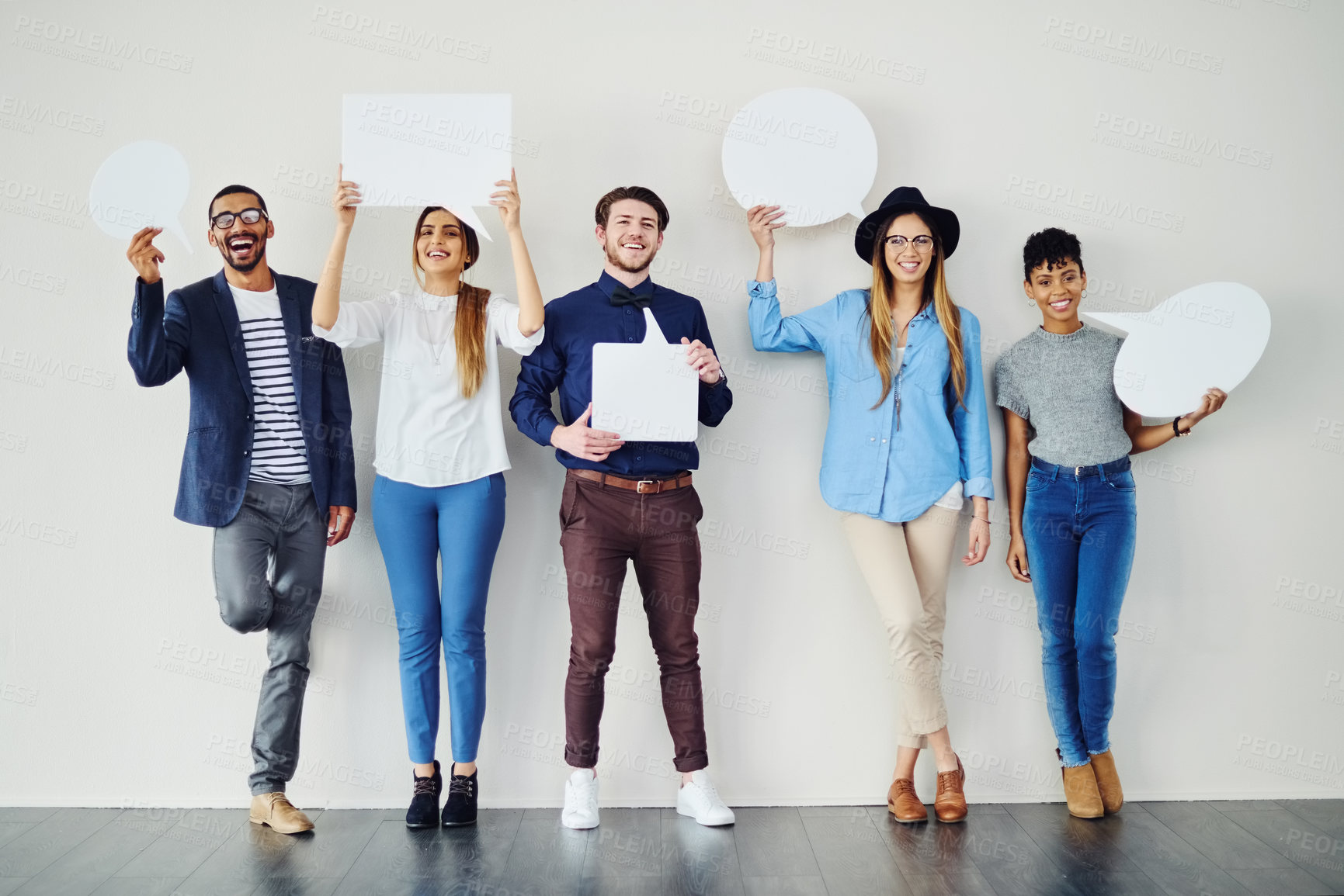 Buy stock photo Shot of a diverse group of creative employees holding up speech bubbles inside