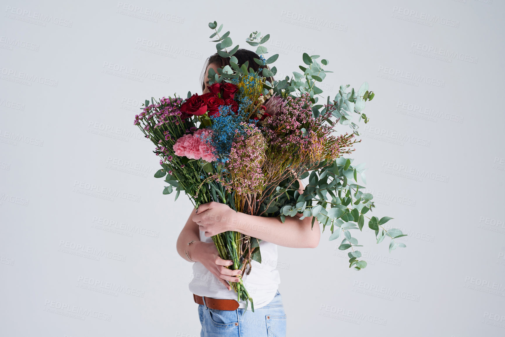Buy stock photo Nature, gift and woman with flowers, creative aesthetics and beauty against a grey background. Female person, model and girl with a floral present, bouquet and covering face with natural products