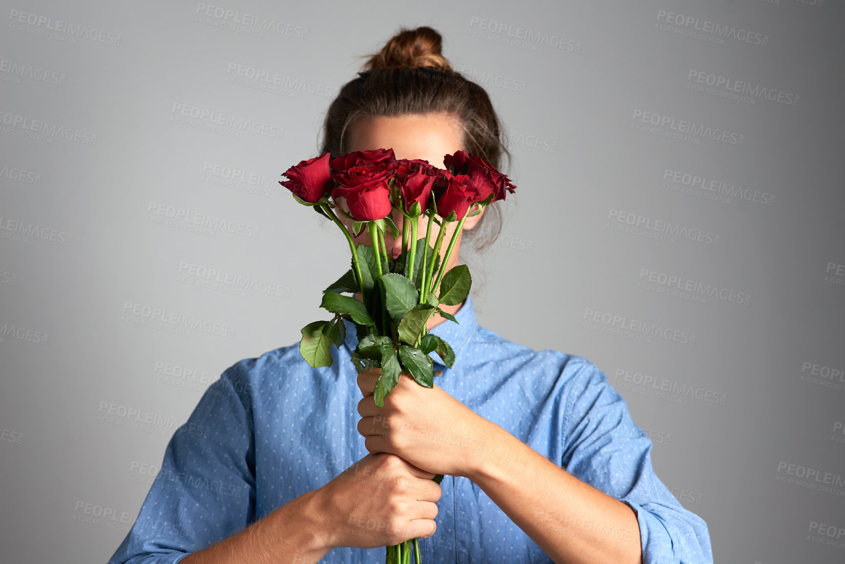 Buy stock photo Hands, mockup or shy girl with bouquet of roses in studio for gift gesture for birthday, anniversary or celebration on grey background. Flower, cover or model behind floral present for valentines day