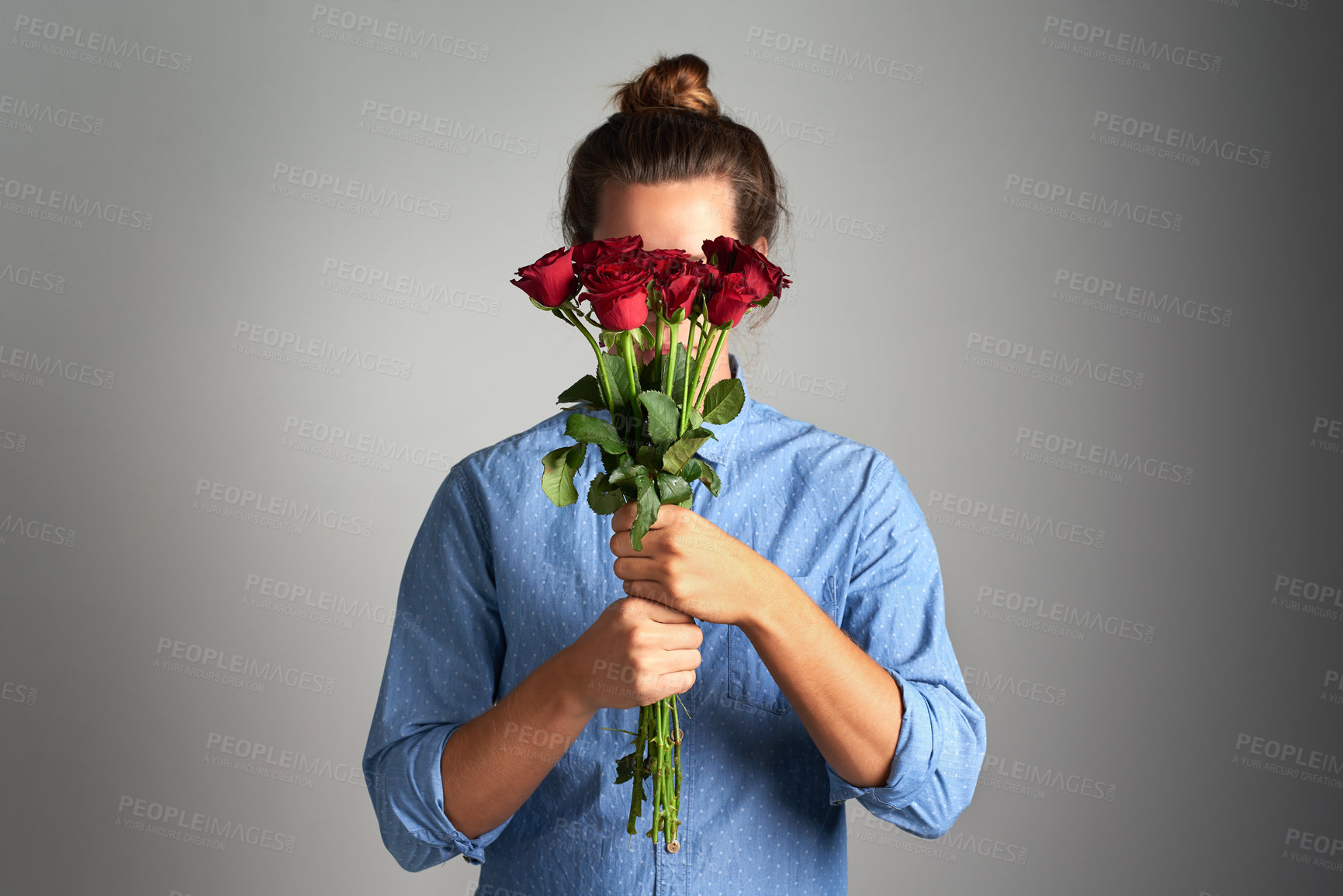 Buy stock photo Rose, gift and shy woman in studio with bouquet for sorry, apology and understanding, mistake and forgiveness on grey background. Plant, hiding and model with flowers for sympathy, empathy or comfort