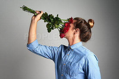 Buy stock photo Studio shot of an unrecognizable man holding flowers against a grey background