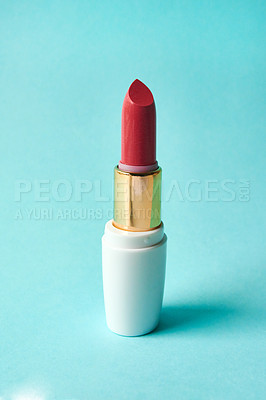 Buy stock photo Studio shot of a tube of lipstick against a blue background