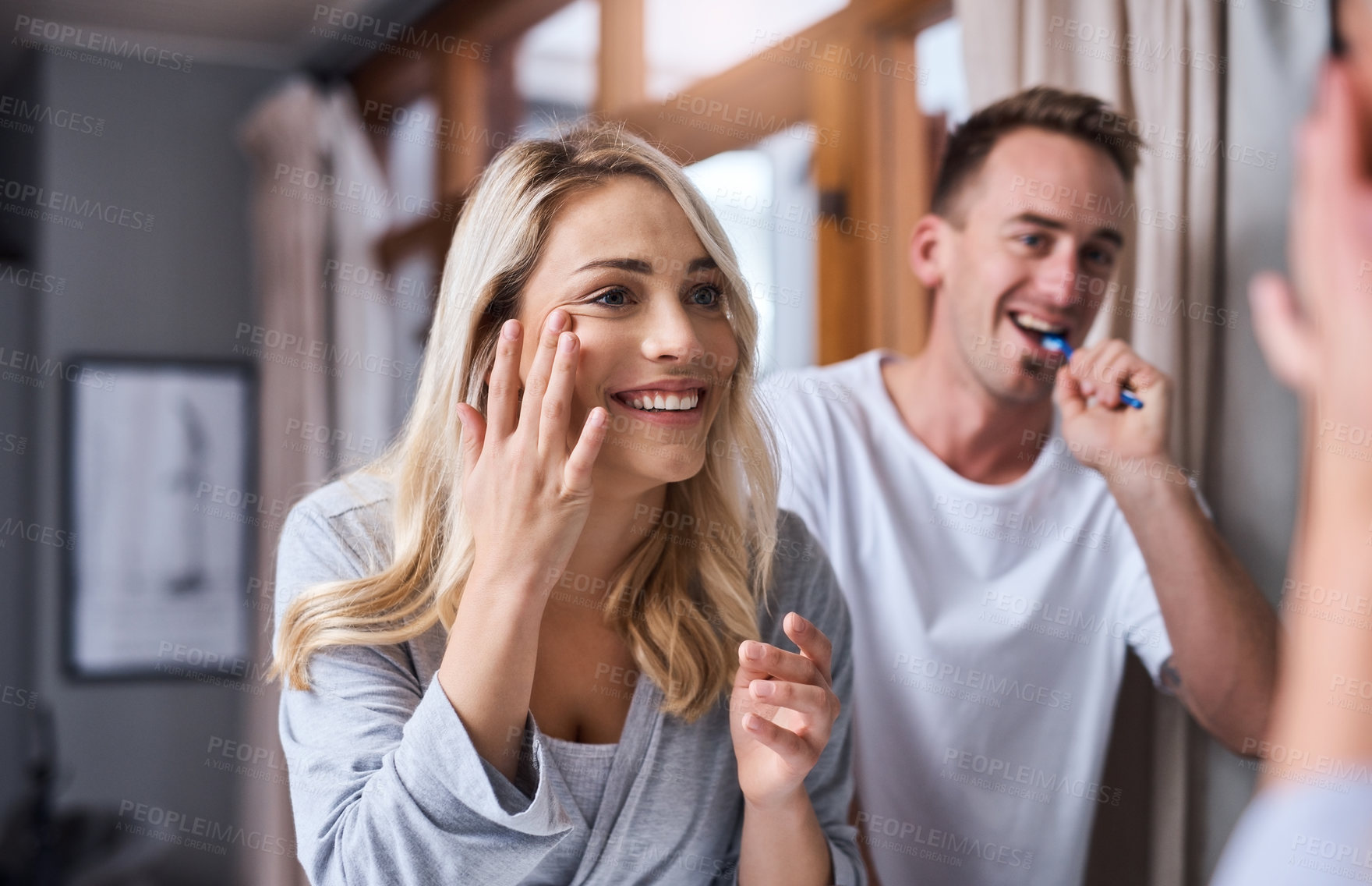 Buy stock photo Bathroom, happy couple and woman on mirror for skincare, beauty and apply facial cream on morning routine. Man, girl and brushing teeth with reflection in home for cleaning, cosmetics and wellness