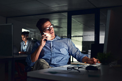 Buy stock photo Cropped shot of a young attractive businessman working late in the office