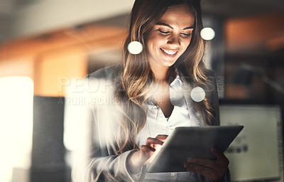 Buy stock photo Working late, overtime and dedication with a happy, positive and motivated business woman working on a tablet in her office. Young female executive smiling while feeling dedicated and determined
