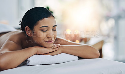 Buy stock photo Shot of a relaxed an cheerful young woman getting a massage indoors at a spa