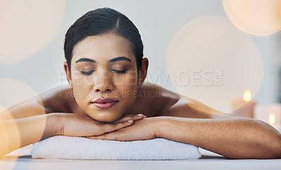 Buy stock photo Shot of a relaxed an cheerful young woman getting a massage indoors at a spa