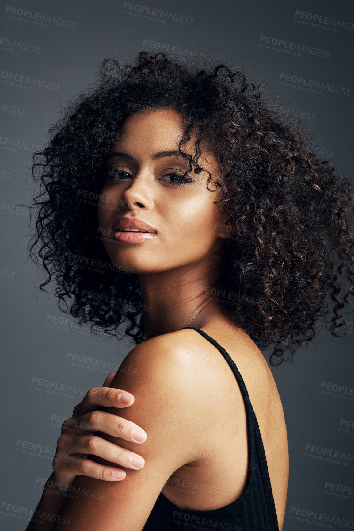 Buy stock photo African woman, portrait and beauty in studio for hair care, natural texture and curly afro with glow. Female person, face and model aesthetic on gray background for confidence, hairstyle and volume