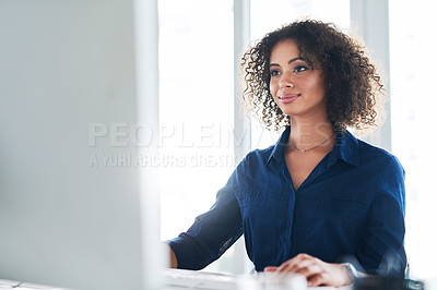 Buy stock photo Cropped shot of an attractive young businesswoman working at her desk in the office