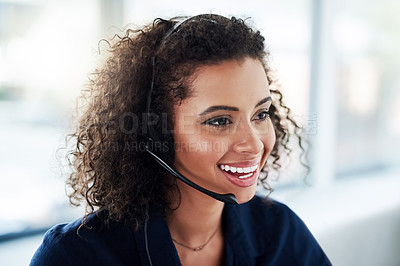 Buy stock photo High angle shot of an attractive young female call center agent working in her office