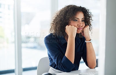 Buy stock photo Cropped shot of an attractive young businesswoman looking bored while working at her desk in the office