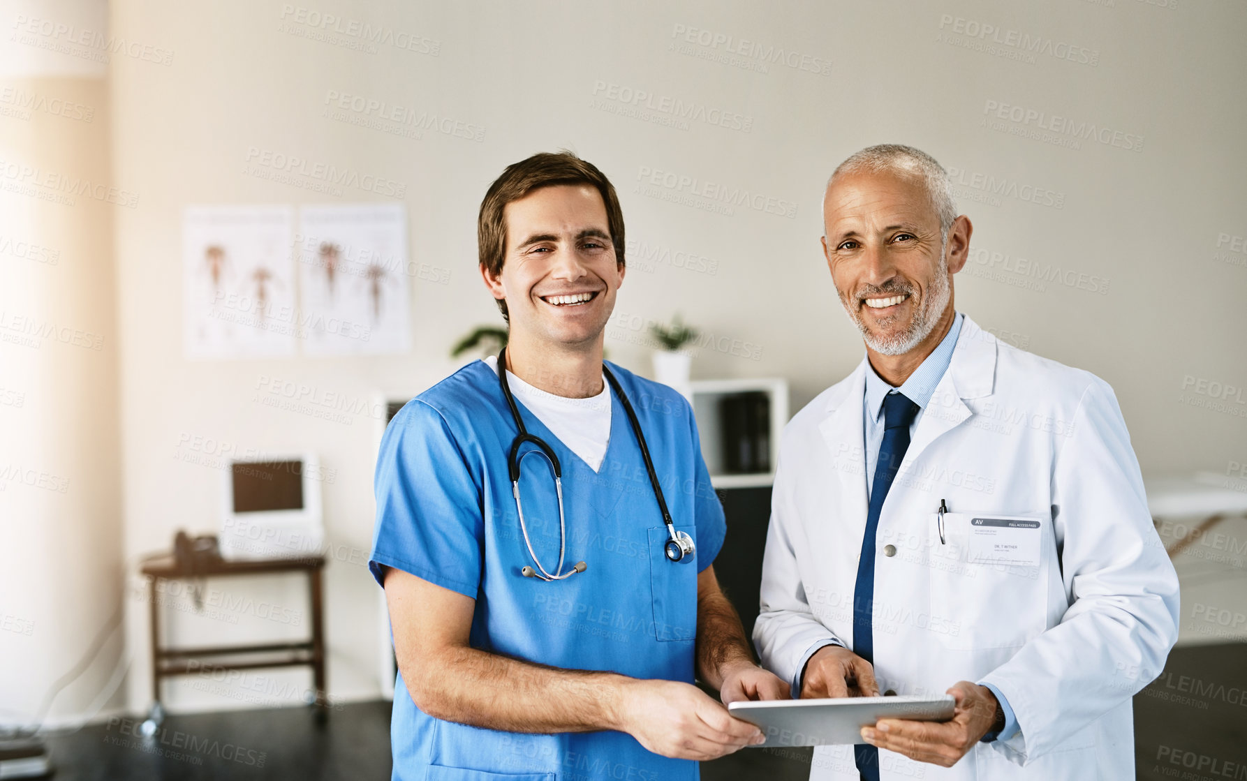 Buy stock photo Portrait of two medical practitioners using a digital tablet in a hospital