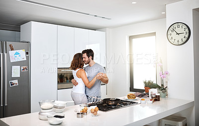 Buy stock photo Shot of young couple dancing in the kitchen while preparing breakfast
