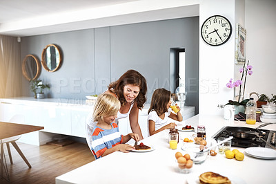 Buy stock photo Young woman enjoyig breakfast with her two children