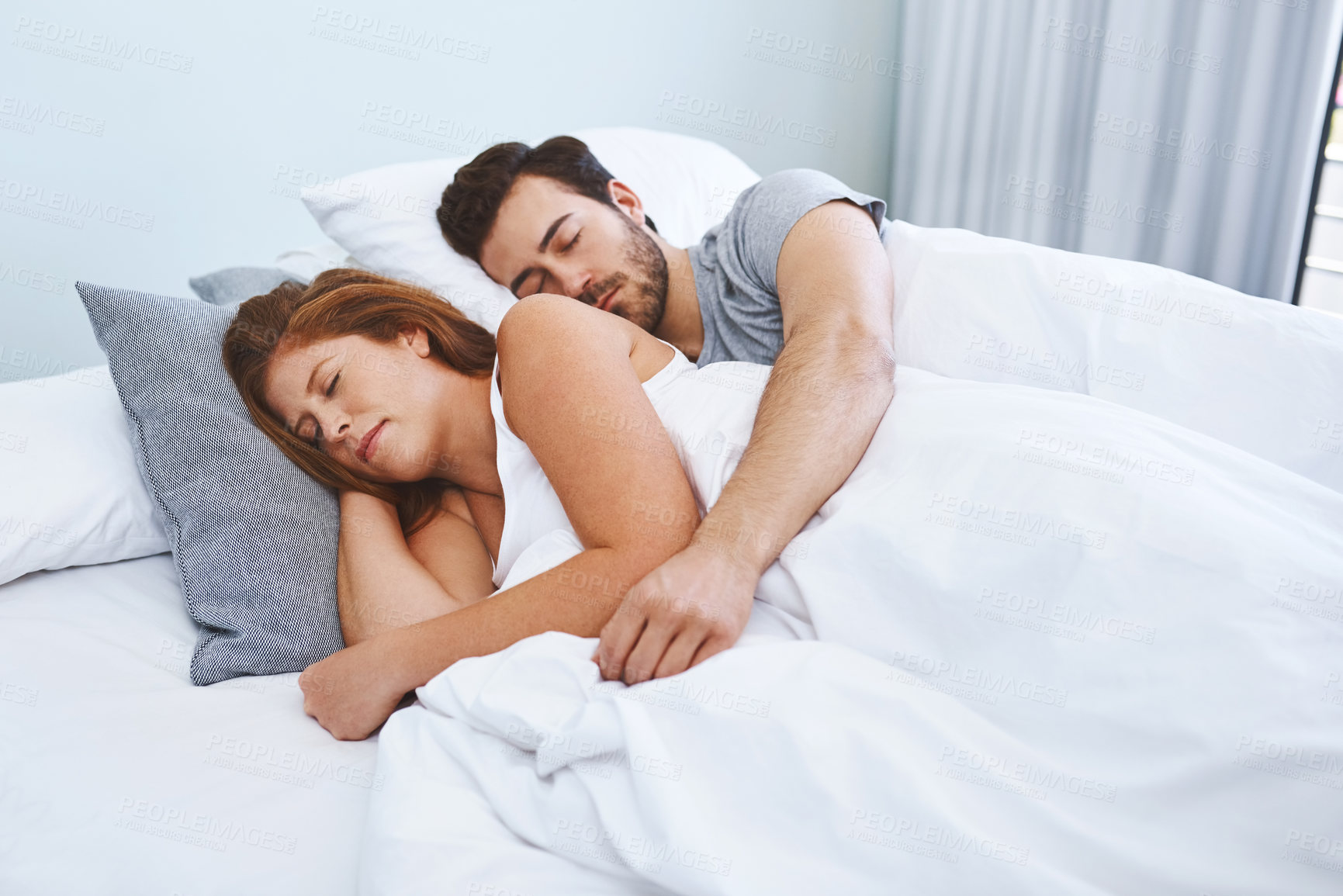 Buy stock photo Sleeping, couple and together in bed, rest and comfortable in bedroom, pillow and tired in house and peace. Home, woman and man with burnout, dreaming and calm in morning, mattress and embrace