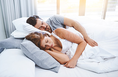 Buy stock photo Shot of a couple sleeping in bed together at home