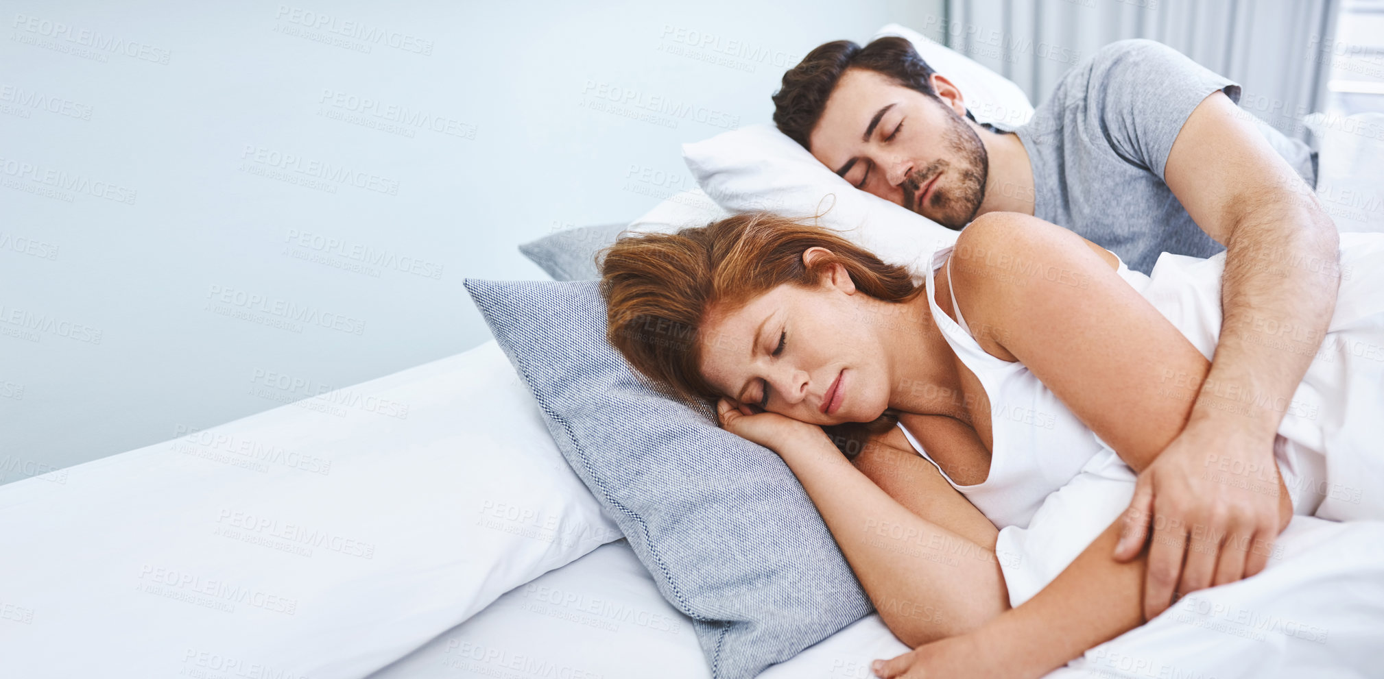 Buy stock photo Shot of a couple sleeping in bed together at home