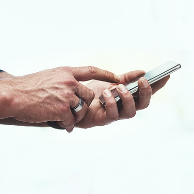 Buy stock photo Cropped shot of an unrecognizable man using his cellphone