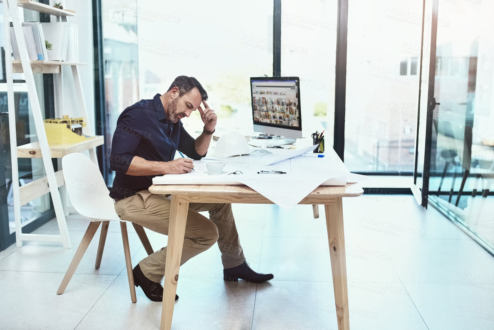 Buy stock photo Tired, mature man or architect and headache from building design mistake with blueprints for planning. Senior, male engineer and computer with documents for panic or stress at house layout deadline