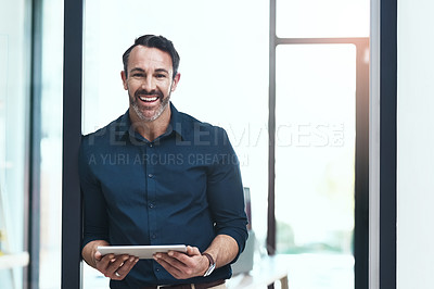 Buy stock photo Cropped shot of a mature businessman working on his tablet in the office