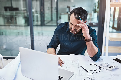 Buy stock photo Shot of a mature male architect using his laptop