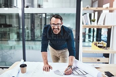 Buy stock photo Shot of a mature male architect working on a design in his office