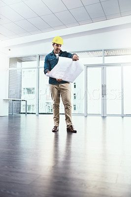 Buy stock photo Shot of a project manager holding blueprints
