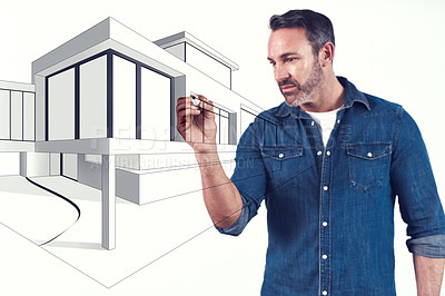 Buy stock photo Shot of an architect drawing up a blueprint