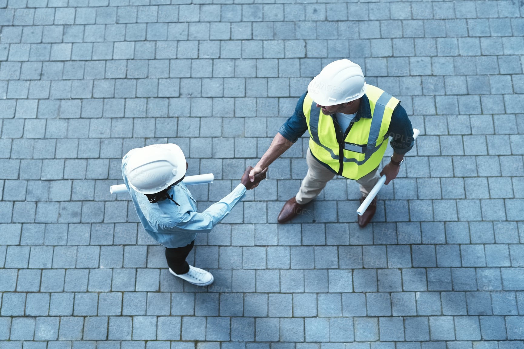 Buy stock photo Shot of two engineers shaking hands