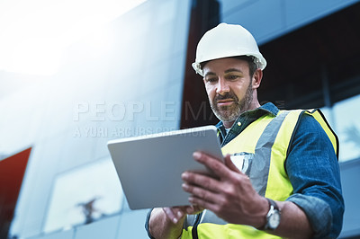 Buy stock photo Shot of a engineer using a digital tablet on a construction site
