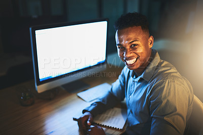 Buy stock photo Cropped portrait of a handsome young businessman working late at night in a modern office